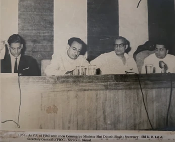 Black and white photo: Ajay Rungta (Dadu) as FIMI VP with Commerce Minister at a panel in 1967.