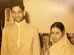 Vintage sepia photo of a young Ajay Rungta (Dadu) standing beside his young wife (Ma), both looking directly at the camera.