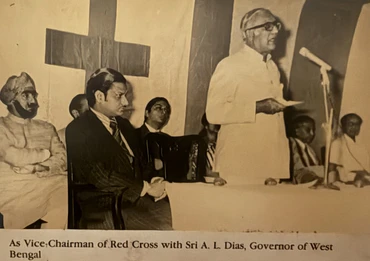 Sepia photo: Ajay Rungta, Vice-Chairman of Red Cross, seated while Governor A.L. Dias of West Bengal speaks at an event.