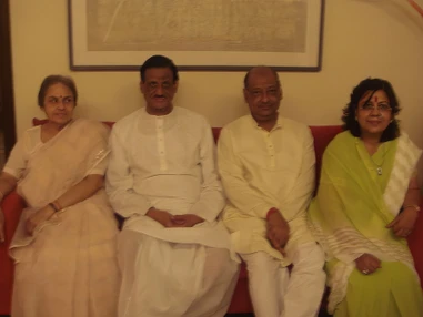 Ajay Rungta (Dadu) in yellow, his wife (Ma), Chotima, and another man, seated on a red sofa.
