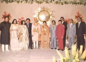 Group photo of Ajay Rungta (Dadu) with family and guests at Manish's wedding. All are in traditional Indian attire on a decorated stage.