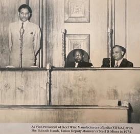 Ajay Rungta speaking at a podium in 1973 as SWMAI Vice-President, with Minister Subodh Handa and another official seated.