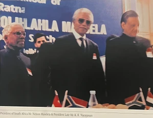 Ajay Rungta standing with Nelson Mandela (center, sunglasses) and President K.R. Narayanan at a formal event.