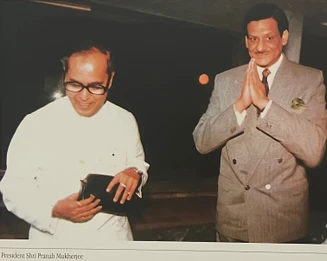 Ajay Rungta respectfully greets President Pranab Mukherjee. Dadu is in a suit with hands in namaste; the President wears white.