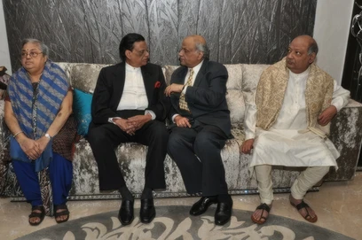 Ajay 'Dadu' Rungta with his mother and two brothers seated on a sofa. A warm family gathering captured indoors.