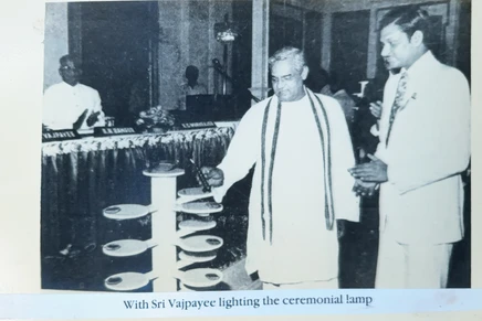 B&W photo: Ajay Rungta (Dadu) watches as Prime Minister Atal Bihari Vajpayee lights a ceremonial lamp.