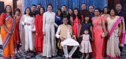 Group photo of Ajay 'Dadu' Rungta sitting with his extended family, all dressed in festive wear, at a celebratory event.