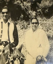 Vintage B&W photo: Ajay Rungta with a friend on holiday. Both wear sunglasses and smart attire. Part of 'holiday with friends' set.